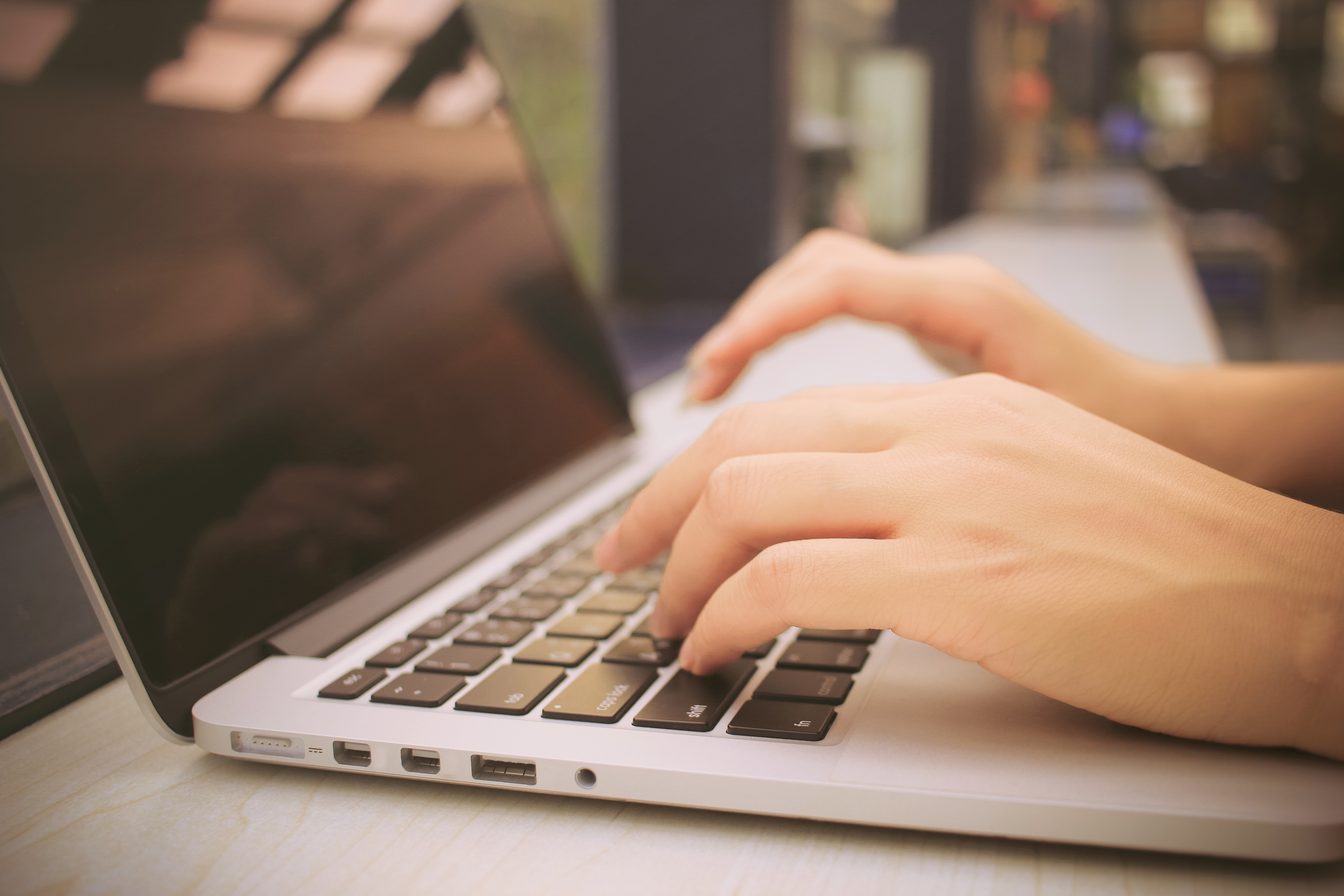 female-hands-typing-on-keyboard-of-laptop-with-retro-filter-effe