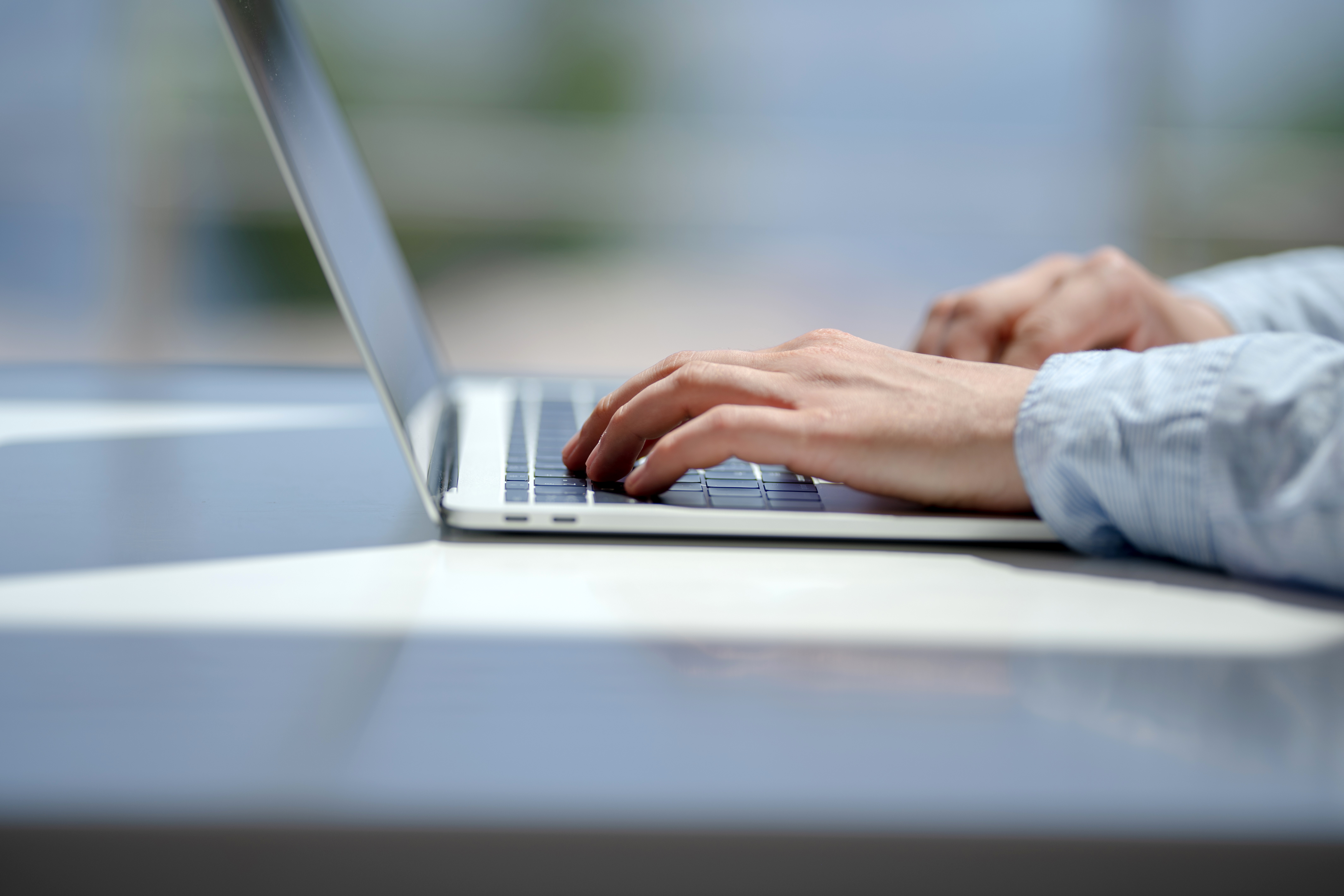 close-up-person-using-laptop-table