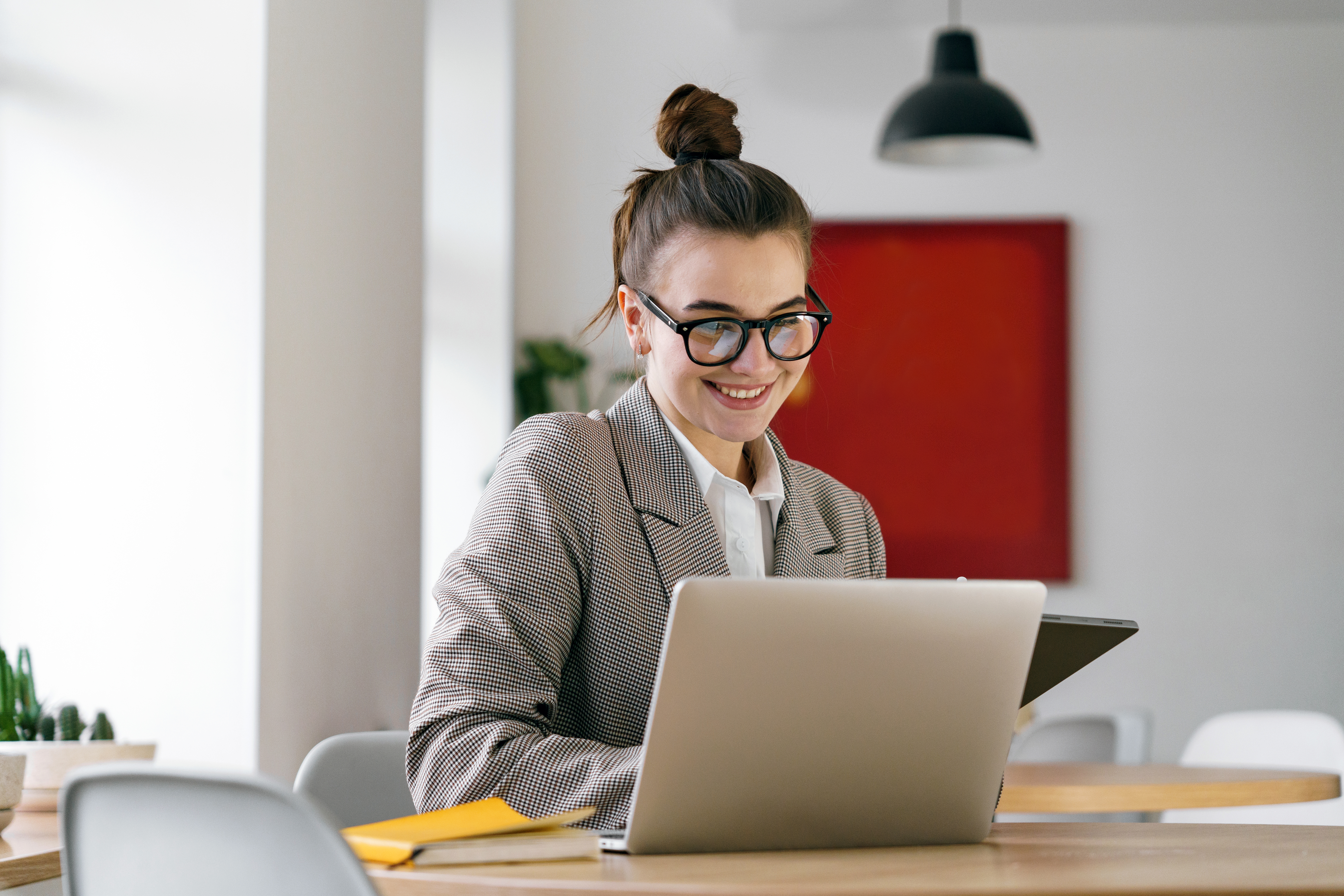 a-cheerful-young-professional-immersed-in-her-laptop-sporting-t