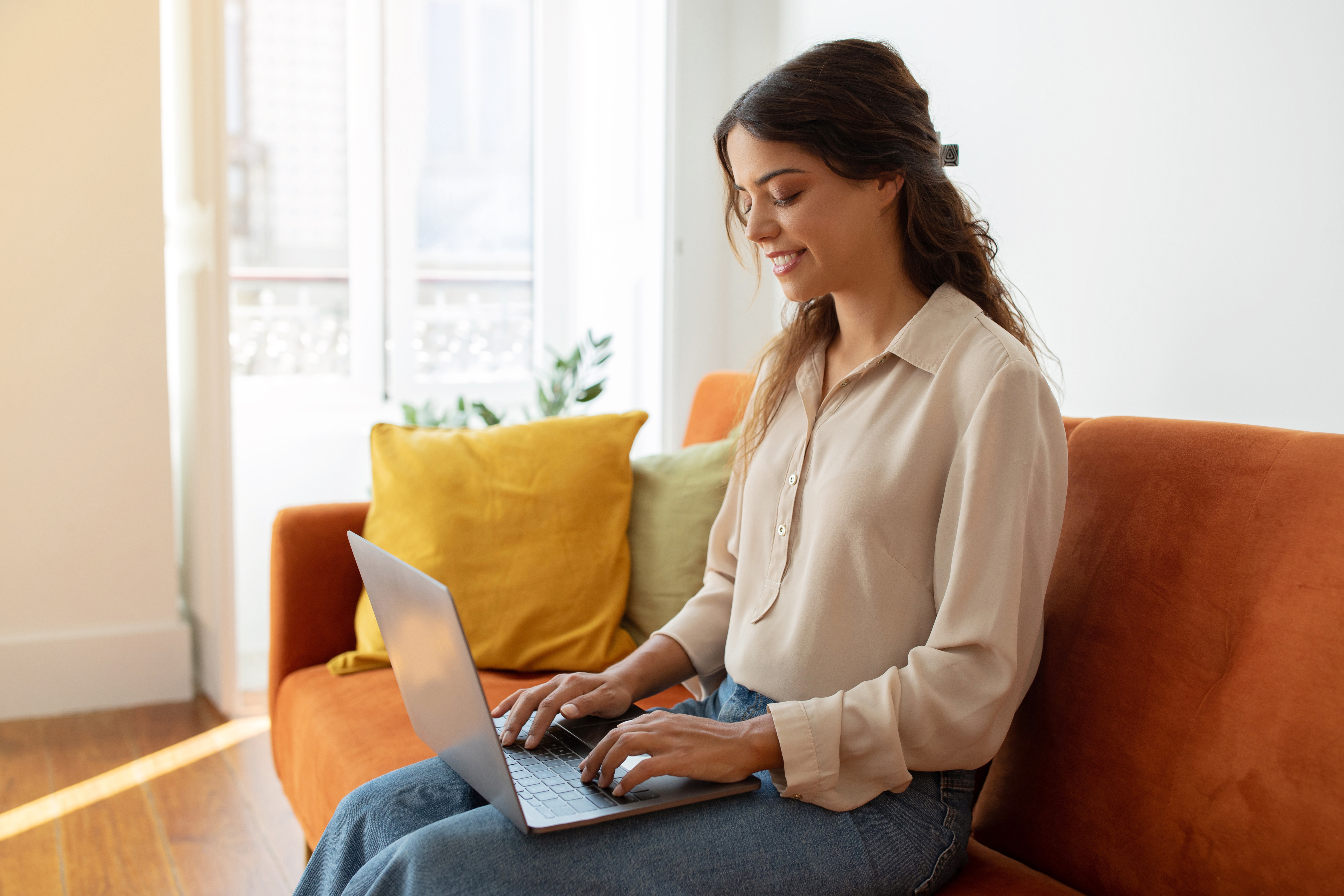 female-study-or-working-with-laptop-while-sitting-on-couch-at-home