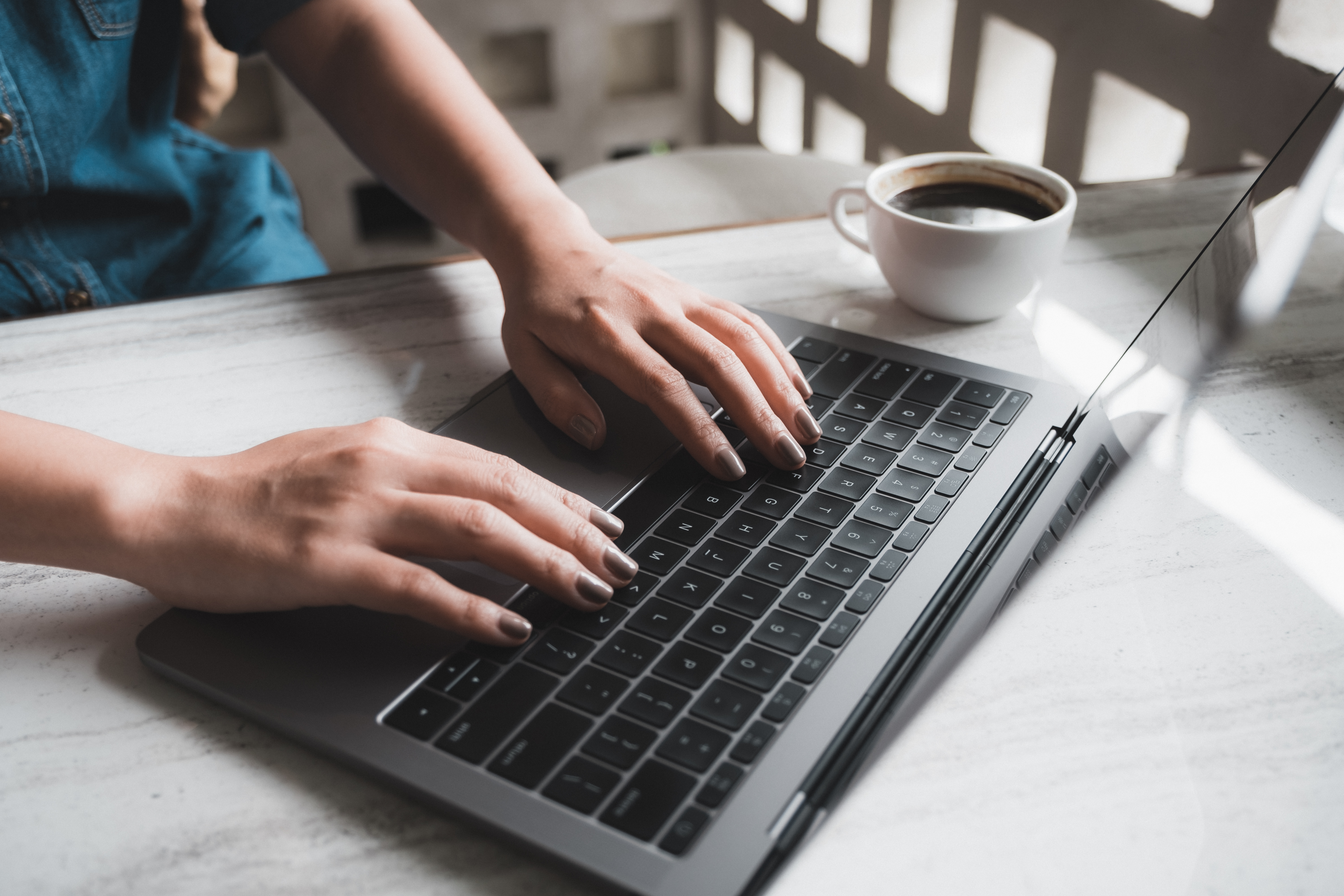 closeup-image-of-a-woman-working-and-typing-on-laptop-keyboard-w