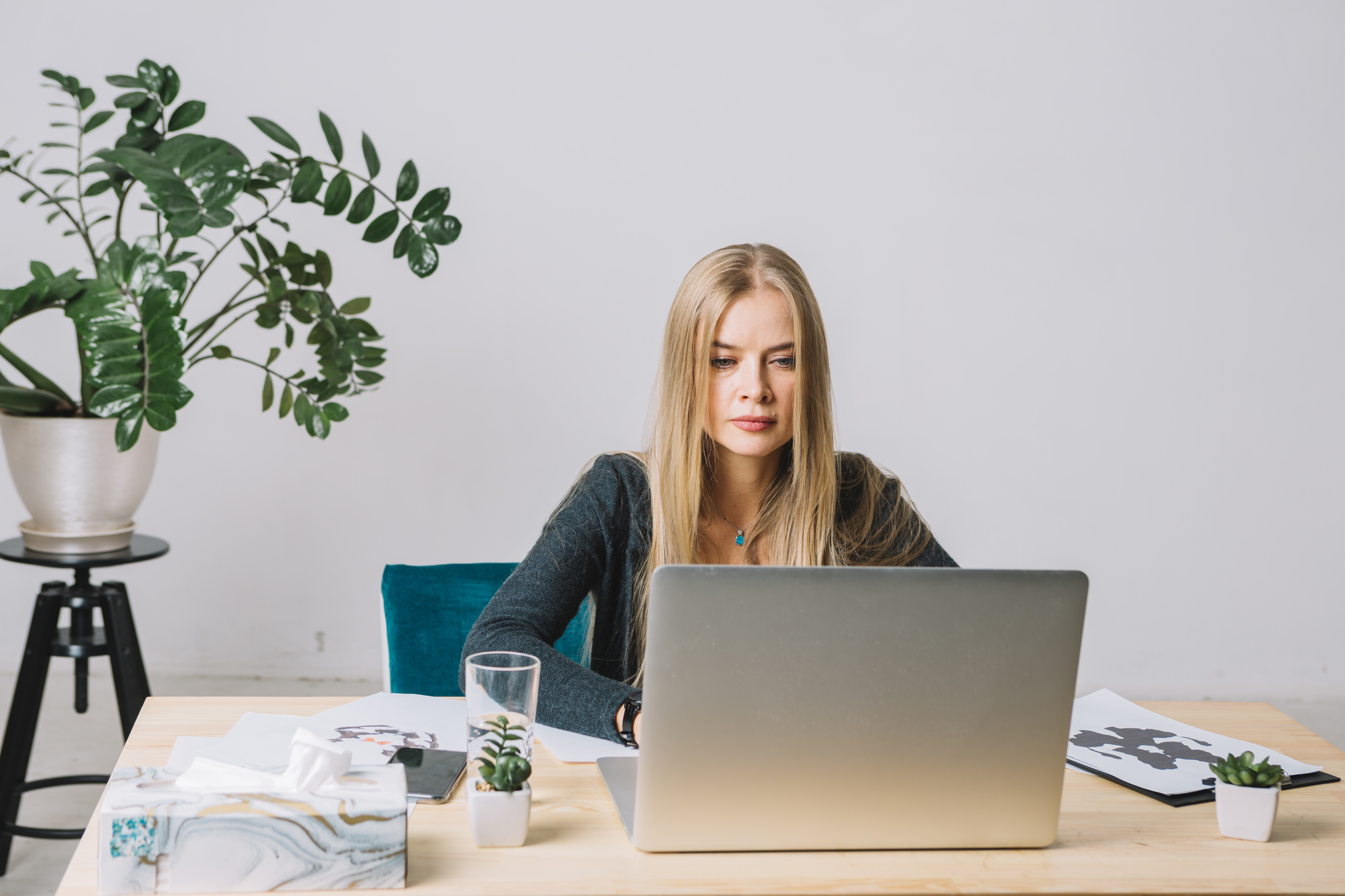 portrait-blonde-young-psychologist-using-laptop-table-office