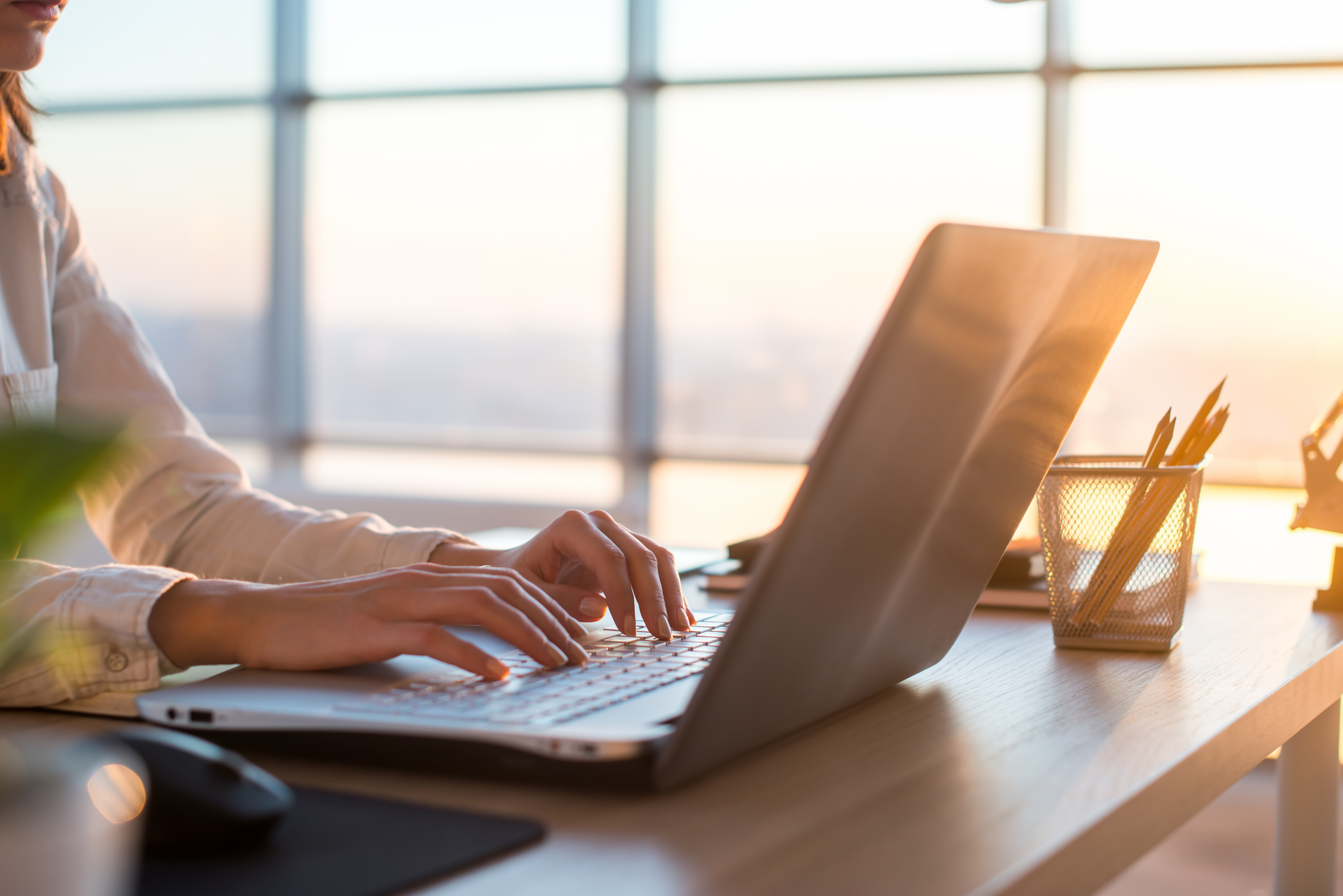 adult-businesswoman-working-at-home-using-computer-studying-business-ideas-on-a-pc-screen-on-line