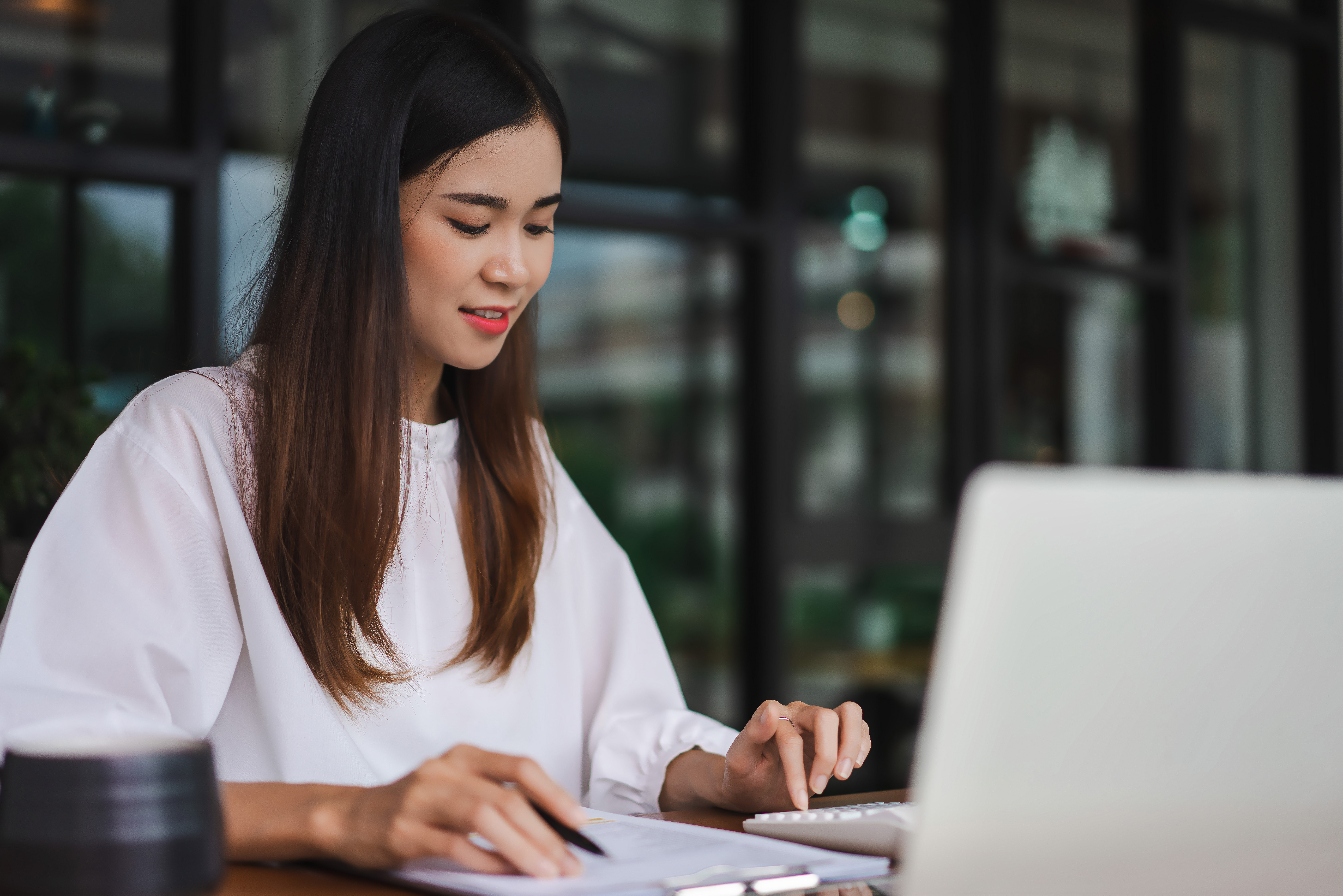 businesswomen-using-calculator-to-checking-financial-document-wh
