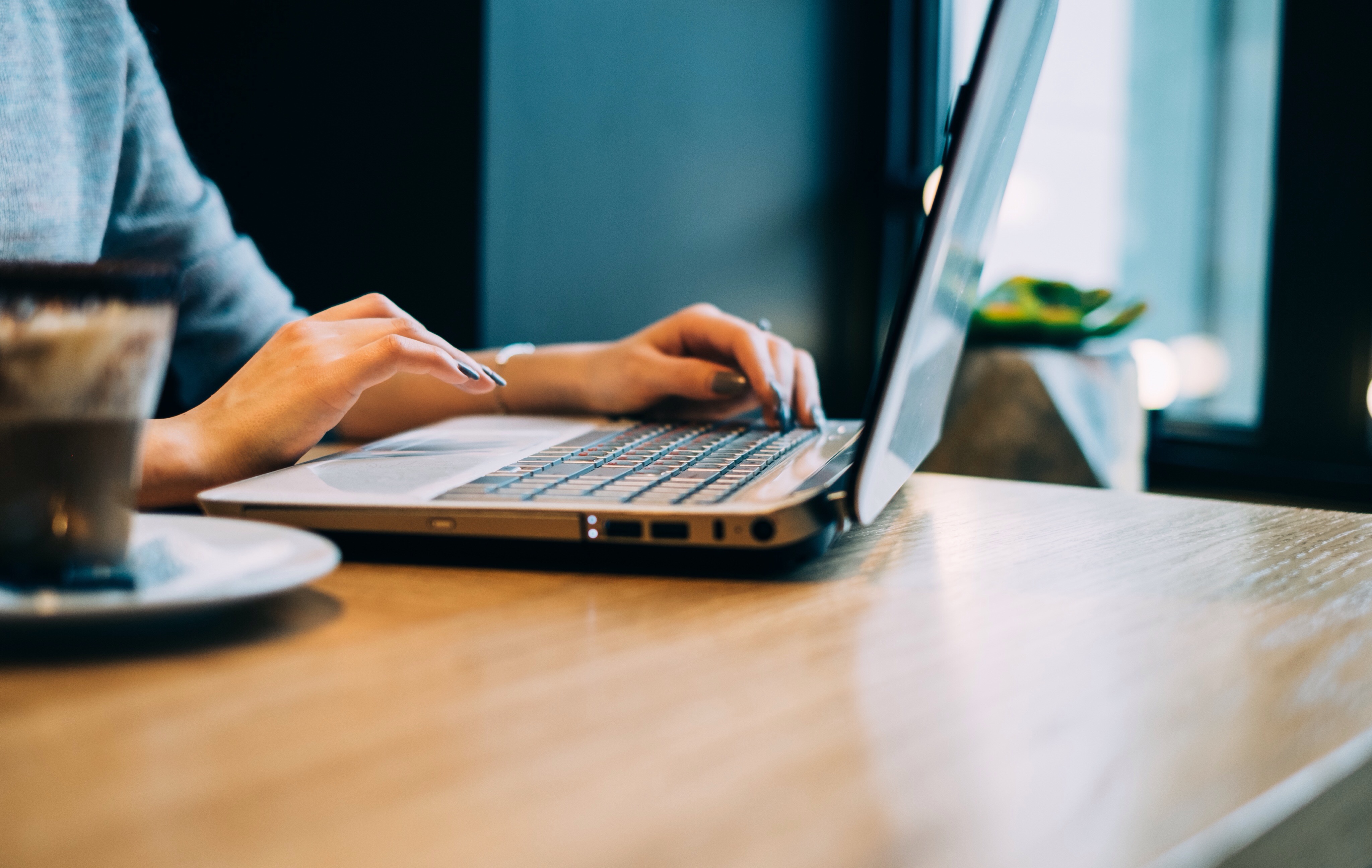 close-up-woman-using-laptop-table