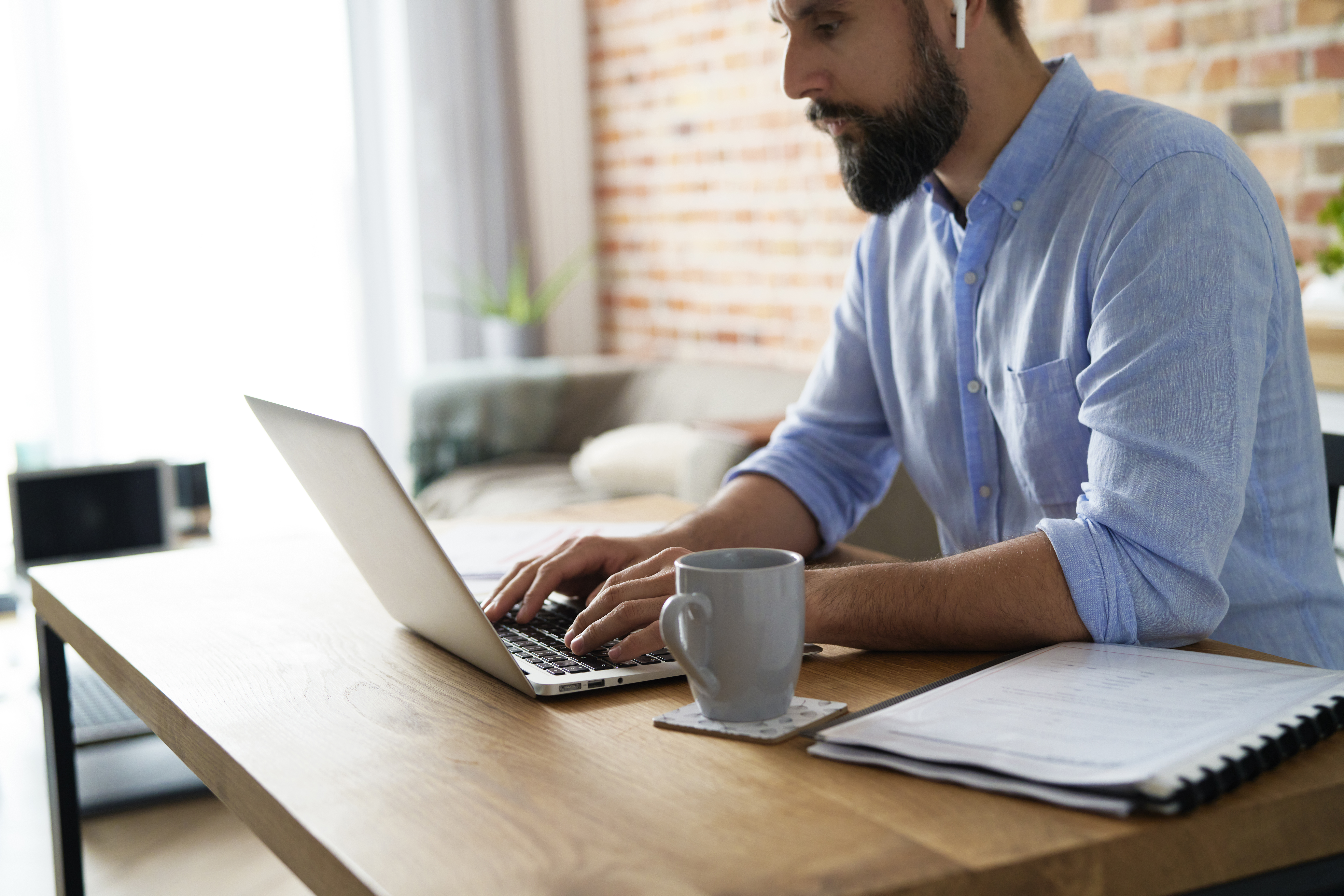 man-working-on-a-laptop-in-the-home-office