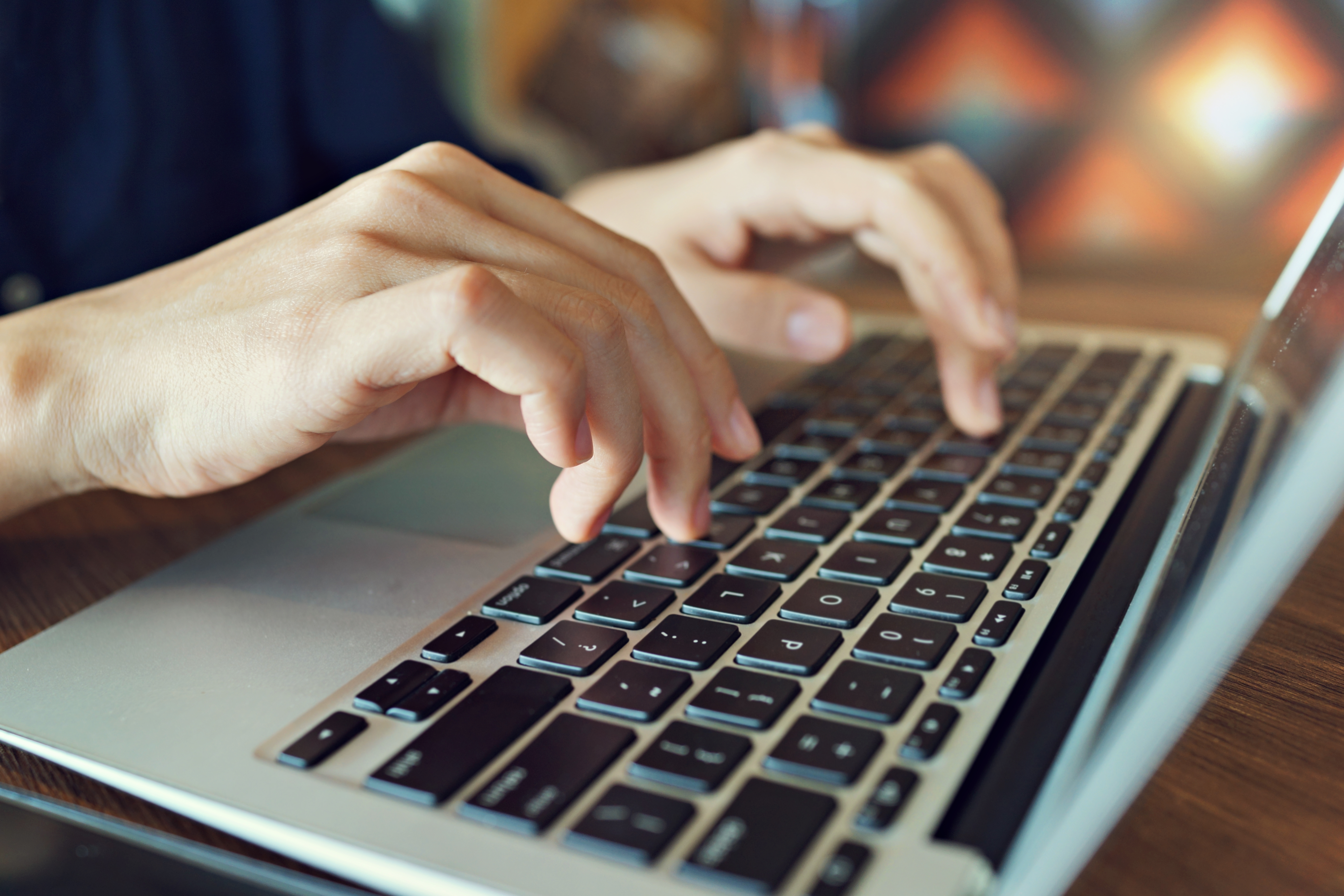 midsection-man-using-laptop-table