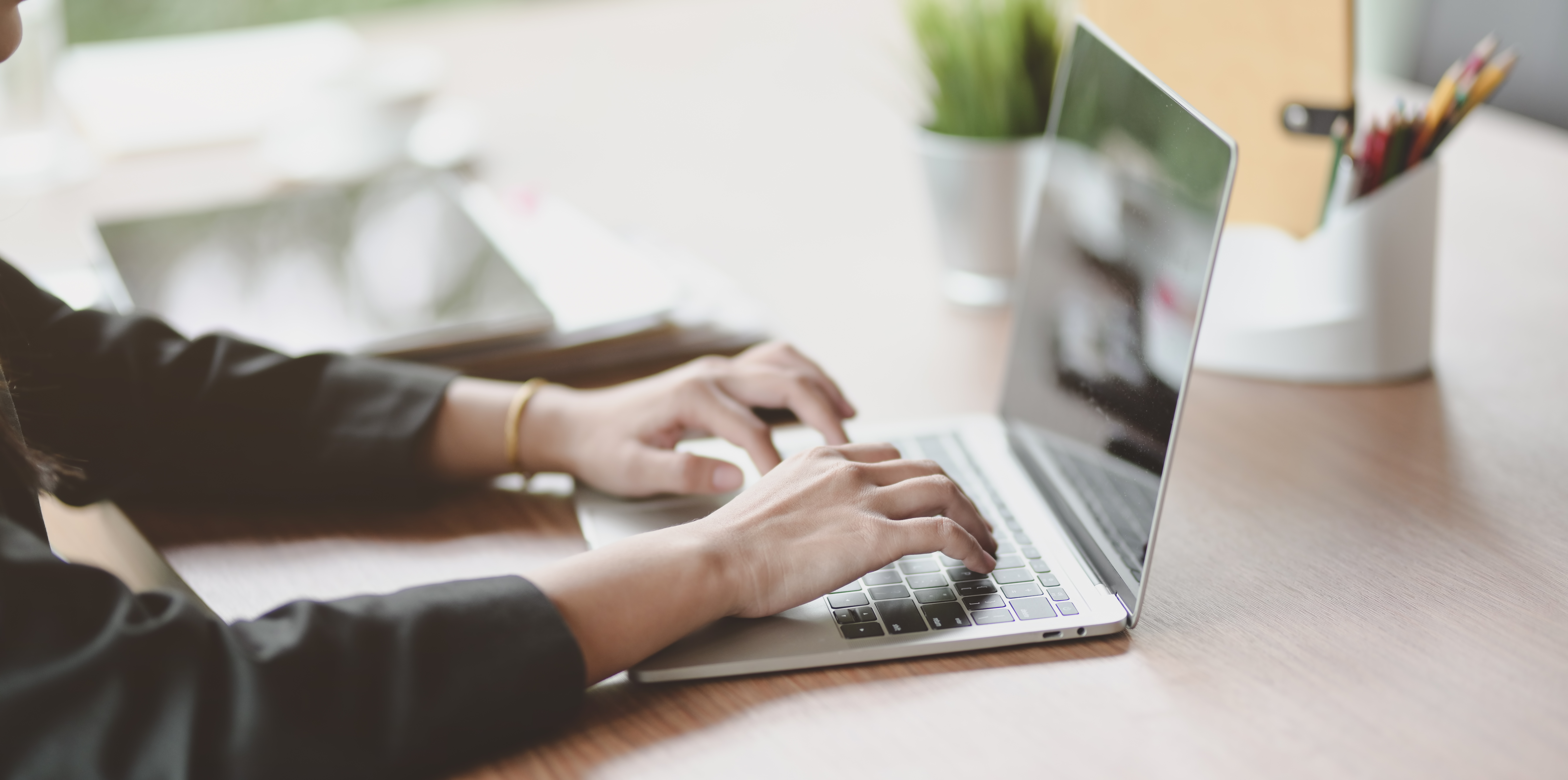 cropped-view-of-businesswoman-typing-on-keyboard-laptop